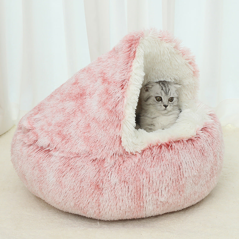 Pink fluffy pet bed with a cat peeking out against a white curtain background