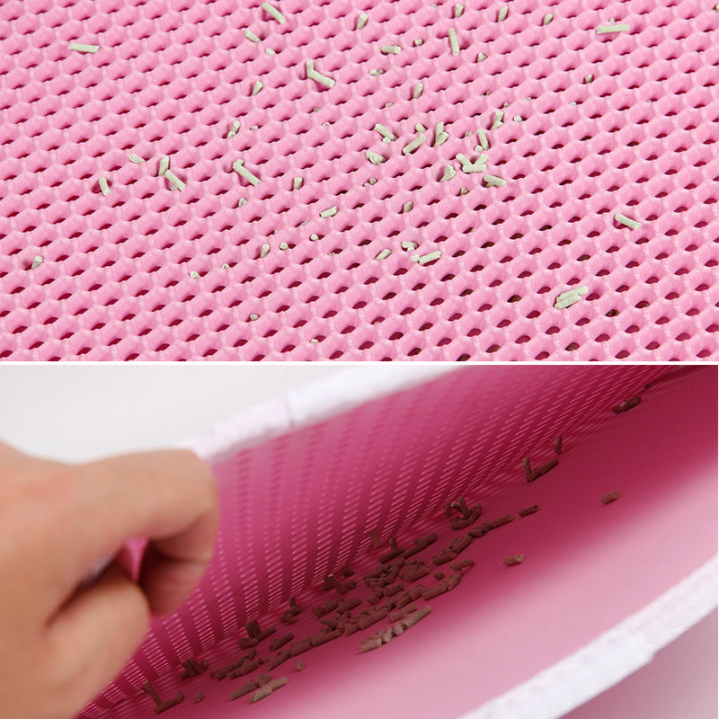 Close-up of pink textured surface with small green particles and a hand holding the material.