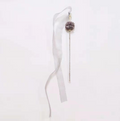 Decorative hair stick with a fluffy top and long ribbon on a white background