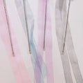 Pastel-colored ribbons with decorative elements on a light background