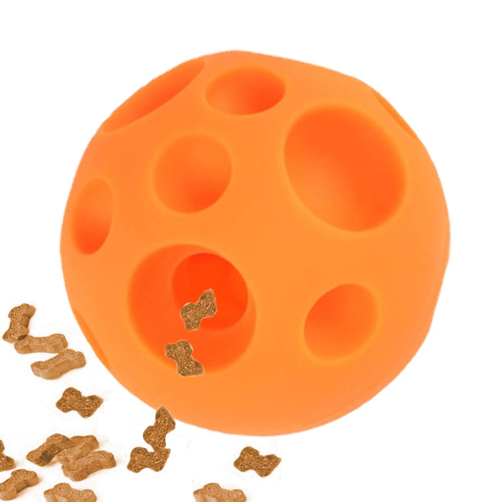Orange dog toy with holes and scattered dog treats on a white background
