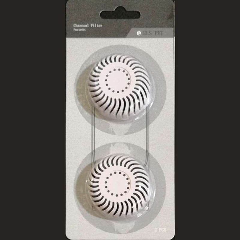 Two charcoal filters on a clear plastic stand with a black background
