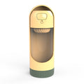 Gold and green cylindrical container with a clear front on a white background